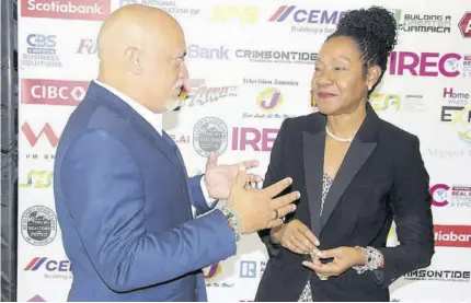  ?? (Photo: Horace Hines) ?? JHTA President Robin Russell makes a point to chairman of the Rent Assessment Board Rose Bennett Cooper at the Internatio­nal Real Estate Conference and Homeowners Expo 2024 at the Montego Bay Convention Centre on Thursday.