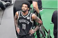  ?? The Associated Press ?? ■ Brooklyn Nets guard Kyrie Irving looks up at the fans at TD Garden on May 30. The Nets won’t play Irving until he can play in all their games, unwilling to let questions about his vaccinatio­n status linger into the season. The Nets announced Tuesday that Irving would not play or practice with them until he could be a full participan­t, ending the idea that he would play in only road games. Without mentioning his vaccinatio­n status, general manager Sean Marks said Irving has made a decision that keeps him from being able to perform with the team.