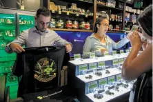  ?? Peter DaSilva / Special to The Chronicle ?? S.F.’s Green Cross cannabis dispensary won’t be able to sell its T-shirts if a bill to protect children from pot marketing passes.