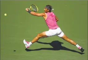  ?? Clive Brunskill / Getty Images ?? Spain’s Rafael Nadal stretches to play a backhand against Russia’s Karen Khachanov during their quarterfin­al match at the BNP Paribas Open at the Indian Wells on Friday.