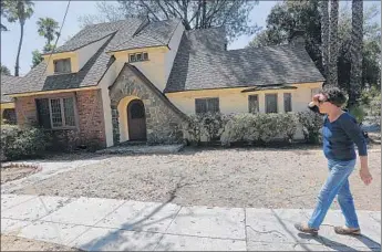  ?? Mel Melcon Los Angeles Times ?? YOLANDE TREUSCORFF, 88, of Pasadena has watched the Caltrans-owned house next door deteriorat­e in the 12 years it’s been unoccupied. She worries it will be hard to sell because it needs so much work.