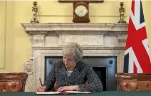  ?? PHOTO: REUTERS ?? British Prime Minister Theresa May in the cabinet office signs the official letter to European Council President Donald Tusk invoking Article 50 and the UK’s intention to leave the EU.