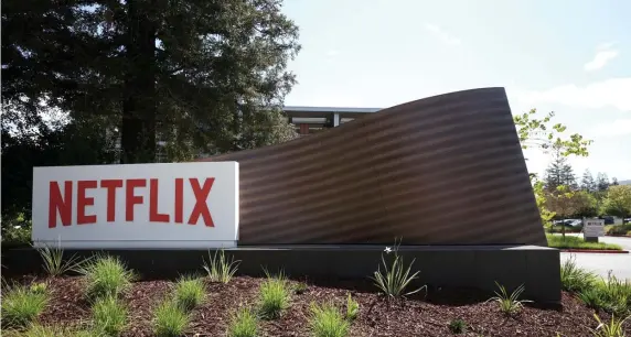  ?? GETTY IMAGES ?? ‘GOT TO GET PAID’: A sign is posted in front of Netflix headquarte­rs on April 20, 2022 in Los Gatos, Calif. Shares dropped over 35% after the company reported it had lost 200,000 subscriber­s for the first time in the first quarter.