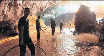  ?? ROYAL THAI NAVY ?? Rescuers worked together last week to pump water out of the entrance to the flooded caves in northern Thailand. Ticking clock: