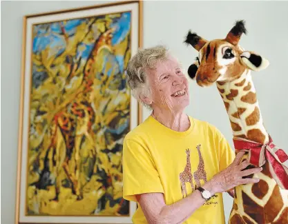  ?? DAVID BEBEE WATERLOO REGION RECORD ?? Above:
Anne Dagg’s Waterloo home is full of giraffe memorabili­a, much of it given to her by people inspired by her life and work.
Left: Dagg, centre, walks with her son Ian and daughter Mary in Waterloo Park recently.