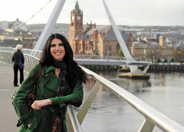  ??  ?? SPAN OF HISTORY: Kathy Donaghy at the Peace Bridge spanning the River Foyle in Derry