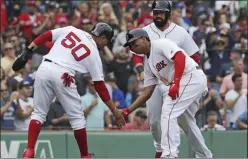  ?? CHARLES KRUPA — THE ASSOCIATED PRESS ?? Red Sox’s Rafael Devers, right, is congratula­ted by Mookie Betts after hitting a three-run homer in the fifth inning of Thursday’s game at Fenway Park in Boston.