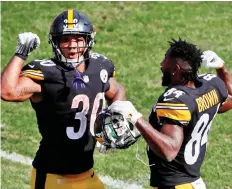  ?? GENE J. PUSKaR/THE ASSOCIATED PRESS ?? The play of Pittsburgh’s second-year running back James Conner, left, has alleviated some of the concerns the Steelers were facing with Le’Veon Bell holding out to start the season. Conner is among the league’s leaders in several key rushing categories.