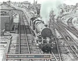  ?? GW RAILWAYANA TRANSPORT TREASURY/GEORGE HEIRON ?? King of the track: GWR No. 6018 King Henry VI passes Weston-super-Mare signalbox with an Up express in the early 1960s. Western-super-Mare station is just out of shot on the left, and top right is the four-platform Locking Road terminus, which closed in September 1964. The 'box was originally named Weston-super-Mare East, but the East was dropped – and painted over – in 1955 when the West signalbox closed. Inset: The nameboard from the signalbox, with the East painted over, that sold at auction on July 24 for £1000 but was stolen just over a week later. It remains unrecovere­d.