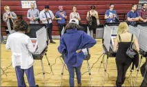  ?? JOHN SPINK / JSPINK@AJC.COM ?? Voters wait in long lines Tuesday to cast their votes at Henry W. Grady High School in Atlanta. Some 57 percent of the state’s registered voters cast ballots that day.