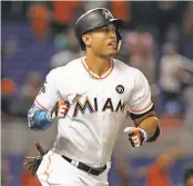  ?? Patrick Farrell / TNS / Miami Herald ?? Giancarlo Stanton homers in Miami in August against the Giants, who hope to add the outfielder’s power via a trade.