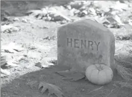  ?? JAMES WALKER, ASSOCIATED PRESS ?? A small pumpkin next to the headstone of 19th-century writer Henry David Thoreau at Sleepy Hollow Cemetery in Concord, Mass.