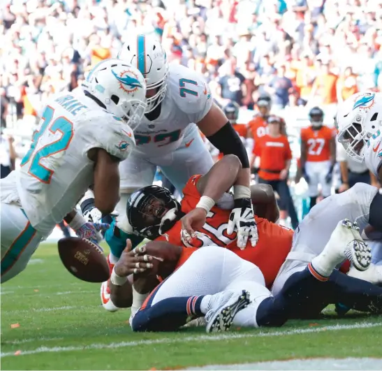  ?? JOEL AUERBACH/AP ?? Running back Kenyan Drake (13 carries, 57 yards) fumbles the ball just before crossing the goal line on the Dolphins’ first possession of overtime.