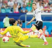  ?? Alexander Hassenstei­n Getty Images ?? LEON GORETZKA of Germany beats Mexico keeper Guillermo Ochoa for the first of his two goals.