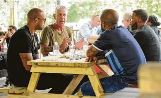  ?? Houston Chronicle file ?? “Parts Unknown” host Anthony Bourdain, second from left, is filmed at Burns Original BBQ in June. Bourdain last featured the barbecue joint on an episode of his previous show in 2003.