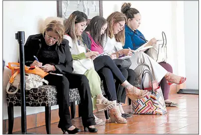 ?? AP file photo ?? Women fill out job applicatio­ns recently at a career fair in Miami Lakes, Fla. Job openings dropped 2.8 percent in December while the number of people leaving their jobs increased 3.1 percent, the U.S. Labor Department reported Tuesday.
