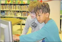  ?? TERESA WRIGHT/ THE GUARDIAN ?? Grade 2 students Moses Collins and Kane MacKinnon were especially engrossed in some educationa­l computer activities at Westwood Primary Friday. The province says it recognizes the increasing needs in Island classrooms and is adding more teachers to the...