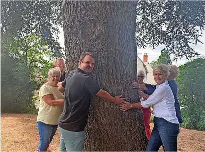  ?? Picture: Tom Stowe ?? Councillor Tom Stowe (centre) intervened to help save the large cedar tree in Cedar Road, Mickleton, after he was contacted by residents