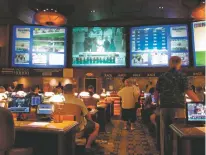  ?? WAYNE PARRY/ASSOCIATED PRESS ?? Bettors wait to make wagers on sporting events Thursday at the Borgata casino in Atlantic City, N.J., hours after it began accepting sports bets.