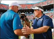  ?? ROB FOLDY / GETTY IMAGES ?? Former Dolphins coach Joe Philbin (left) shaking hands with Patriots coach Bill Belichick after Miami beat
New England 33-20 on Sept. 7, 2014. Philbin also beat Belichick’s Patriots at home in 2013.