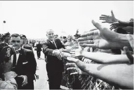  ?? George Tames / New York Times ?? President Lyndon B. Johnson greets a crowd in 1964, a year marked by several LBJ initiative­s that family members and supporters say should be heralded.