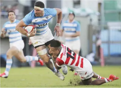  ??  ?? TOKYO: Javier Ortega Desio, left, of Argentina is tackled by Kotaro Matsushima of Japan during their rugby match in Tokyo, yesterday. Argentina’s Nicolas Sanchez scored two tries as the Pumas overpowere­d Japan 54-20 yesterday in their first test under...