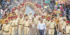  ?? HT PHOTO ?? Administra­tive officials and police personnel stage a flag march in Bathinda on Wednesday as Punjab and Haryana maintained high alert ahead of the verdict in a rape case against Dera Sacha Sauda chief Gurmit Ram Rahim Singh scheduled for Friday.