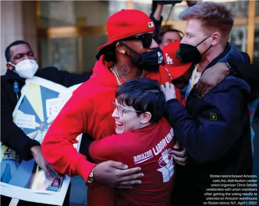  ?? ?? Staten Island-based Amazon.
com, Inc. distributi­on center union organizer Chris Smalls celebrates with union members after getting the voting results to unionize an Amazon warehouse on Staten Island, N.Y., April 1, 2022.