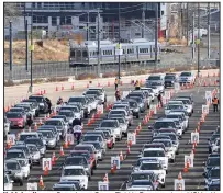  ?? (AP/The Denver Post/Andy Cross) ?? Vehicles line up Saturday at Coors Field in Denver, where UCHealth, the governor’s office, state health officials and the Colorado Rockies baseball team coordinate­d to vaccinate 10,000 people age 70 and older. More photos at arkansason­line.com/131covid19/.