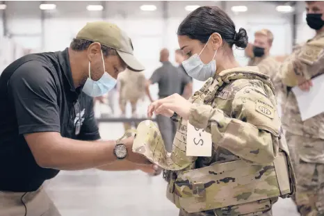  ?? JASON AMADI/U.S. ARMY ?? Sgt. Katiushka Rivera, a soldier assigned to the 82nd Airborne, gets fitted for a modular scalable vest during a fielding event last month at Fort Bragg, North Carolina.