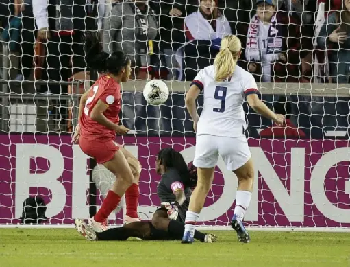  ?? Bob Levey/Getty Images ?? The United States’ Lindsey Horan beats goalkeeper Yenith Bailey of Panama in the first half of an Olympic qualifier Friday in Houston, Texas. Horan scored three times in the Americans’ 8-0 win.