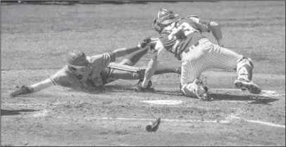  ?? The Associated Press ?? OUT AT HOME: Ole Miss’ Ryan Olenek (2) is tagged out by Arkansas catcher Grant Koch (33) during the Rebels’ 11-10 home victory Saturday in Oxford, Miss. Bruce Newman/Oxford Eagle.