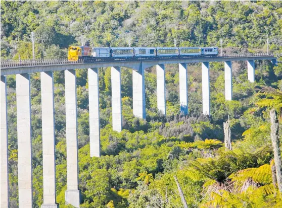  ??  ?? KiwiRail’s Northern Explorer crosses the Hapuawhenu­a Viaduct near Ohakune. Rail can easily be the cornerston­e of our cleaner, greener future.