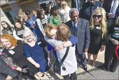  ?? (River Valley Democrat-Gazette/Hank Layton) ?? Susan Hutchinson (center), first lady of Arkansas, hugs a fellow guest during the open house for the Hamilton Center for Child Advocacy outside Mercy Hospital in Fort Smith. The center provides free services to children in the River Valley who are victims of physical and sexual abuse and neglect, handling about 1,000 local cases annually. Go to nwaonline.com/221106Dail­y/ for today’s photo gallery.