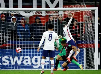 ?? Kirk Irwin, Getty Images ?? Christian Pulisic of the United States heads the ball past Guillermo Ochoa of Mexico for a goal during the second half of the FIFA World Cup qualifier on Friday night in Cincinnati.