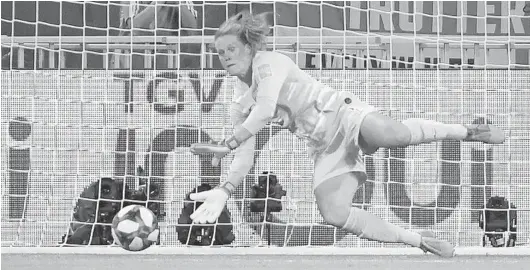  ?? JEAN-PIERRE CLATOT/GETTY-AFP ?? U.S. goalkeeper Alyssa Naeher saves a penalty kick during the Women’s World Cup semifinal match against England on Tuesday at the Lyon Stadium in Decines-Charpieu, France.