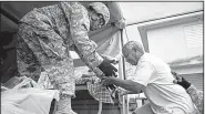  ?? AP/CARLOS GIUSTI ?? National Guard soldiers evacuate residents Friday in Toa Baja, Puerto Rico.