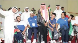  ??  ?? His Highness the Crown Prince Sheikh Nawaf Al-Ahmad Al-Jaber Al-Sabah takes a ‘selfie’ with disabled athletes. —KUNA photos