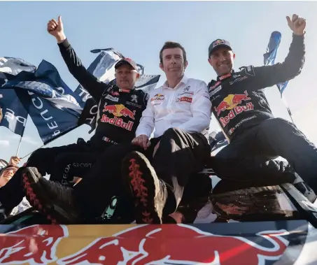  ??  ?? French driver Stephane Peterhanse­l (right), co-driver Jean Paul Cottret (left), and Peugeot’s sports manager Bruno Famin celebrate their first place in the Dakar Rally in Rio Cuarto, Argentina.