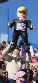  ??  ?? A man holds a piñata figure of Donald Trump during the Women’s March voter registrati­on tour launch Las Vegas, Nevada, at the weekend