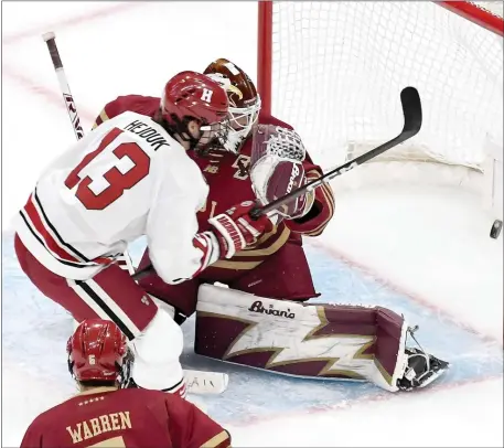  ?? PHOTOS BY MARK STOCKWELL — BOSTON HERALD ?? Harvard’s Marek Hejduk (13) puts the puck past Boston College goalie Mitch Benson to score during the first period of the Beanpot men’s hockey semifinal at TD Garden.