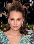  ??  ?? Below: Alicia Vikander wears earrings by Louis Vuitton