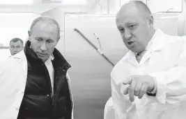  ?? ALEXEY DRUZHININ TNS file ?? Yevgeny Prigozhin, right, ordered his Wagner group mercenarie­s to retreat to their camps in Ukraine, thus defusing the crisis that represente­d a significan­t challenge to President Vladimir Putin’s leadership. The men are pictured during a factory tour in 2010.