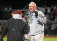  ?? AUSTIN HERTZOG - DIGITAL FIRST MEDIA ?? Pottsgrove head coach Rick Pennypacke­r won’t take the district championsh­ip trophy from athletic director Gary Derenzo after the Falcons defeated Upper Perkiomen in the final on Nov. 10.