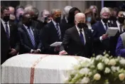  ?? EVAN VUCCI — THE ASSOCIATED PRESS ?? President Joe Biden places his hand on the casket of former Secretary of State Madeleine Albright during the funeral service at the Washington National Cathedral in Washington on Wednesday.