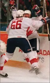  ?? BLAISE EDWARDS, CANADIAN PRESS ARCHIVES ?? Mario Lemieux rushes into the arms of teammate Wayne Gretzky after he scored the game winner in their Canada Cup final match against the Soviet Union.