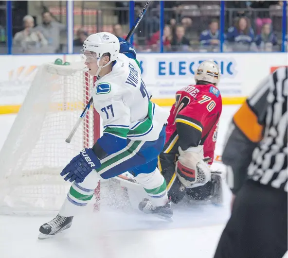  ?? — SHAUGHN BUTTS/EDMONTON JOURNAL FILES ?? Jake Virtanen of the Vancouver Canucks prospects scored an overtime winning goal on Nick Schneider of the Calgary Flames prospects at the South Okanagan Events Centre in Penticton during last year’s Young Stars tournament.