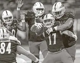  ?? Ronald Cortes/Contributo­r / ?? UTSA's Kaedrick Cobbs celebrate the first rushing touchdown of his college career with teammates in the fourth quarter on Saturday at the Alamodome.