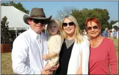 ?? NWA Democrat-Gazette/CARIN SCHOPPMEYE­R ?? Josh and Allison Tritt (from left), holding Josie Tritt, and Judy Gaines help welcome Life Styles supporters to the 24th annual Polo in the Ozarks at Buell Farm in Goshen.