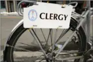  ?? STEVEN SENNE — THE ASSOCIATED PRESS ?? A plate featuring the word “clergy” is attached to a bicycle belonging to Everett.